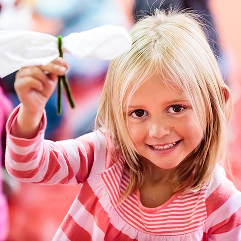  Photo of student holding a craft project.